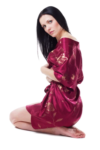 Beautiful woman in red dressing gown — Stock Photo, Image