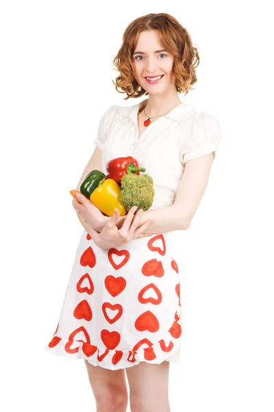 Young beautiful woman holding a bunch of fresh vegetables — Stock Photo, Image