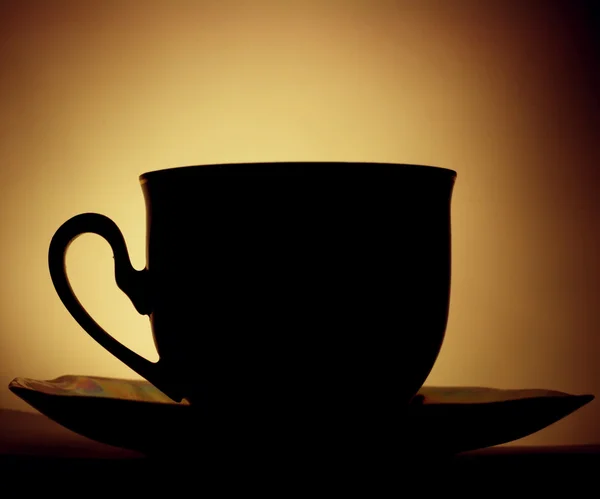 Kaffekopp i bakgrundsbelysningen — Stockfoto