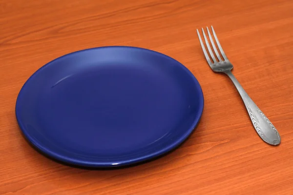 Plate with a fork — Stock Photo, Image