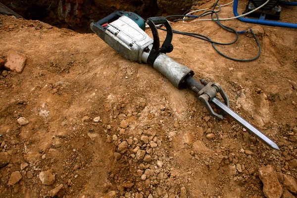Pneumatic hammer lying on the ground — Stock Photo, Image