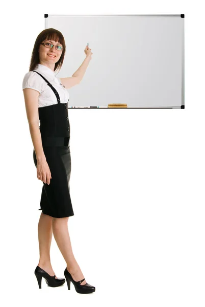 Young woman in businesssuit pointing on whiteboard — Stock Photo, Image