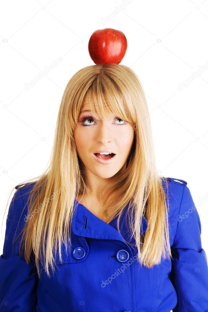 Funny young woman with an apple on her head