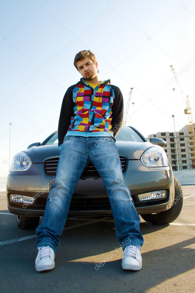 Handsome young man with his car