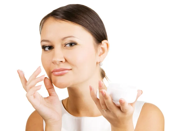 Young beautiful woman applying skin cream — Stock Photo, Image
