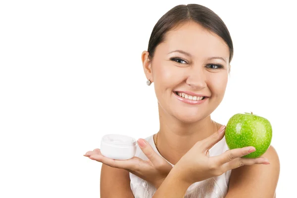 Young beautiful woman holding an apple and skin cream — Stock Photo, Image