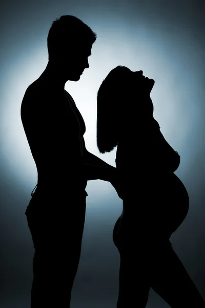 Silhouette of a young couple expecting a baby — Stock Photo, Image