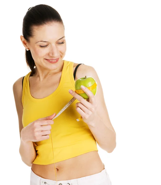 Schöne schlanke Frau hält einen grünen Apfel — Stockfoto