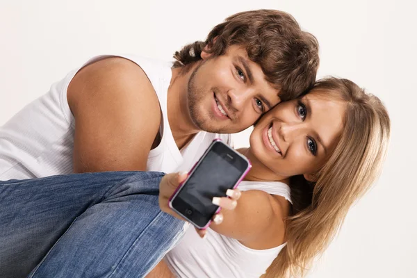 Beautiful couple with a mobile phone — Zdjęcie stockowe