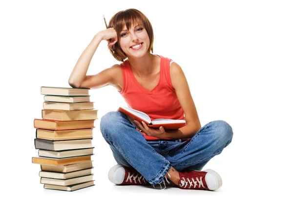 Прекрасный студент с стопкой книг — стоковое фото