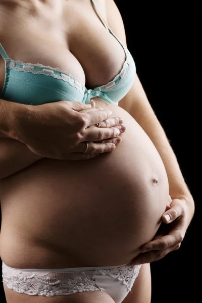 Buik van een zwangere vrouw Stockfoto
