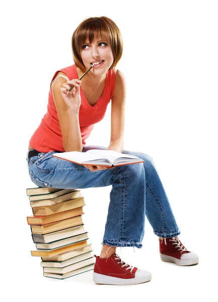 Schöne Studentin mit einem Stapel Bücher Stockbild