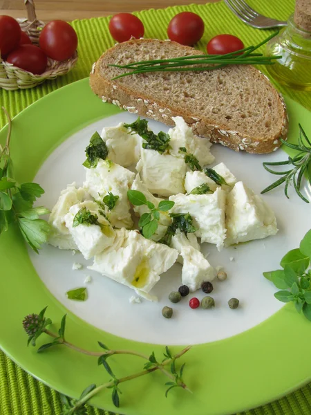 Sheep's milk cheese with herb dressing — Stock Photo, Image