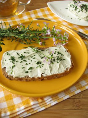 Herb curd with Cuckoo Flower on bread clipart