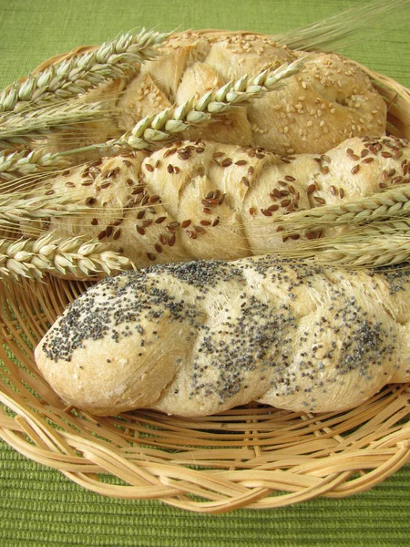 Yeast braids with poppy, sesame and linseeds in basket — Stock Photo, Image