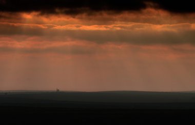 Cornish Tin mine on horizon during storm. clipart