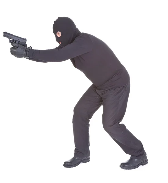 stock image Robber aiming with his gun