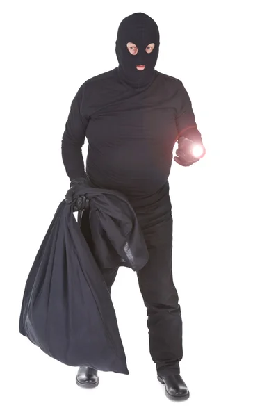 Bandyta z latarką i worek na białym tle — Zdjęcie stockowe