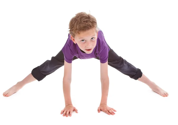 Litte boy is trying to make spine — Stock Photo, Image