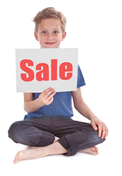 Stock image Boy holding white page with sale word