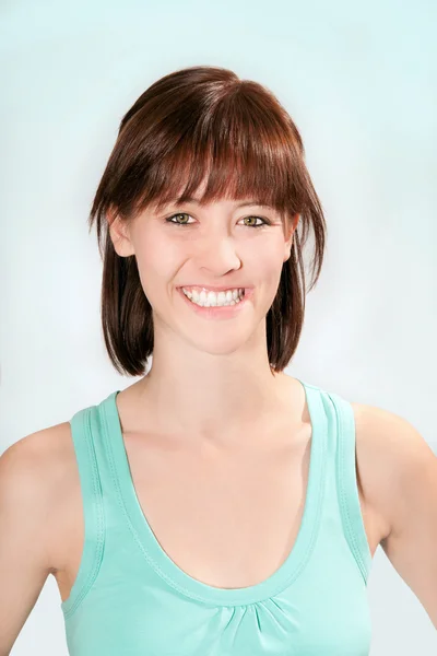 Portrait of a young woman in turquoise top — Stock Photo, Image
