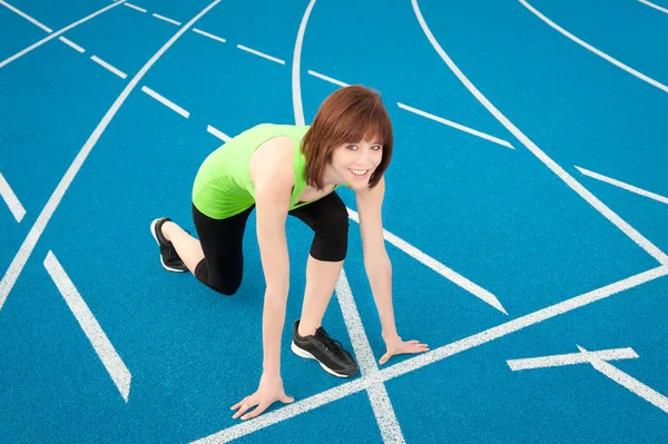 Stock image Athletic woman on a running track