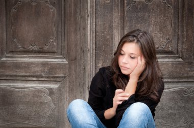 Teenage girl looking thoughtful about troubles clipart