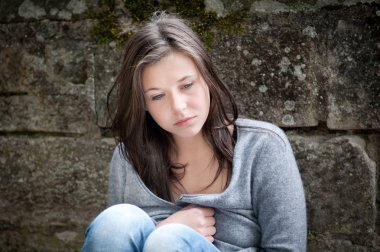 Teenage girl looking thoughtful about troubles clipart