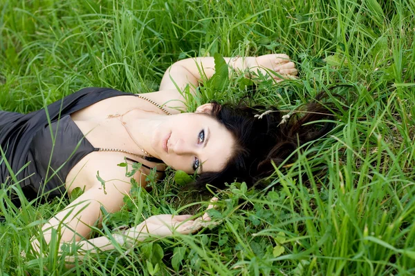 Красивая девушка лежит на траве — стоковое фото