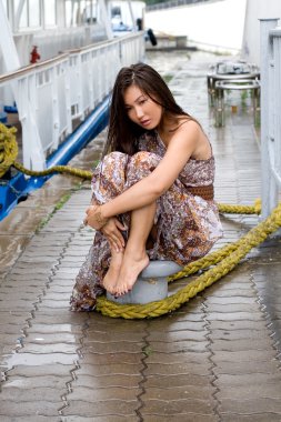 Girl walking outdoor on embankment under rain clipart