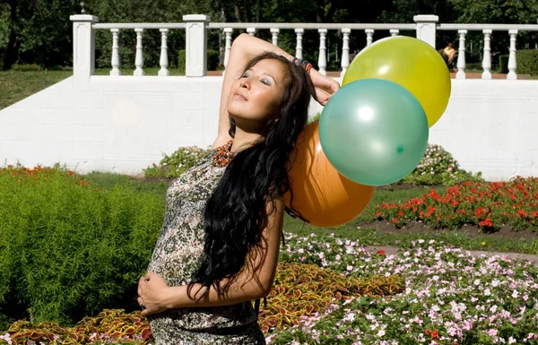 Joyful pregnant girl with colorful balloons — Stock Photo, Image
