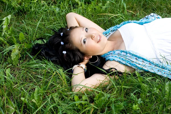 Krásná těhotná dívka leží na trávě — Stock fotografie
