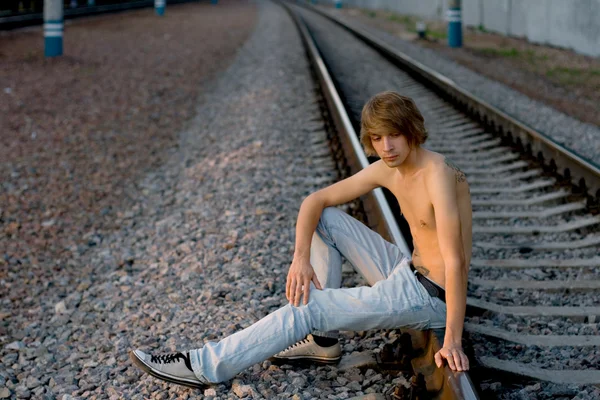 Handsome man walking near rails — Stock Photo, Image
