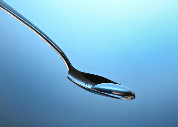 Spoon with a liquid — Stock Photo, Image