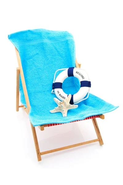Beach chair with blue towel and life buoy — Stock Photo, Image