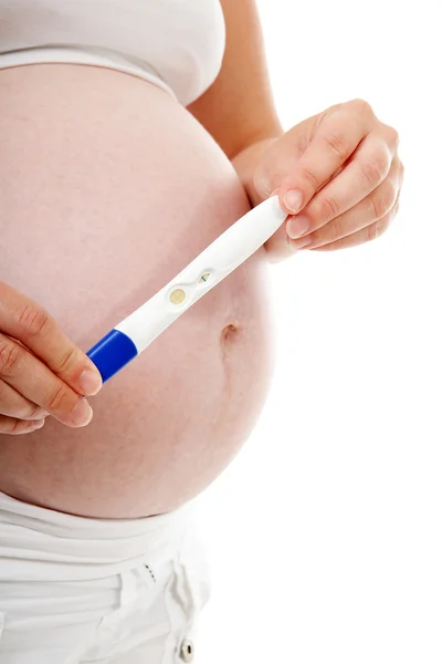 Woman is holding pregnancy test — Stock Photo, Image