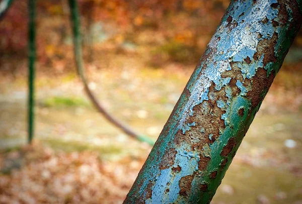 Part of an old rusted swingset — Stock Photo, Image