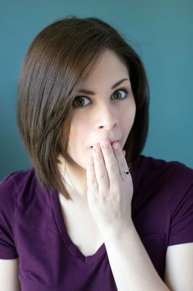 Young woman covering mouth — Stock Photo, Image