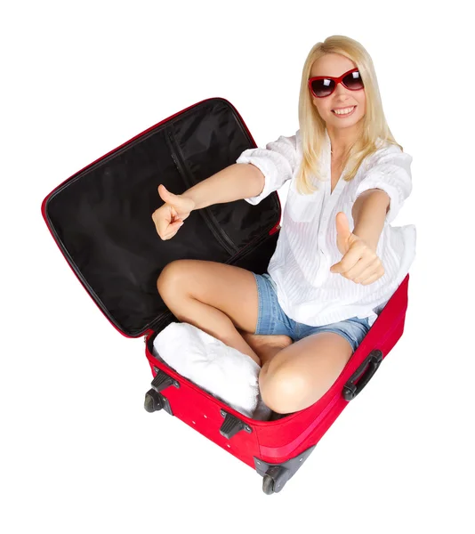 Woman showing thumbs up in travel suitcase packed for vacation — Stock Photo, Image