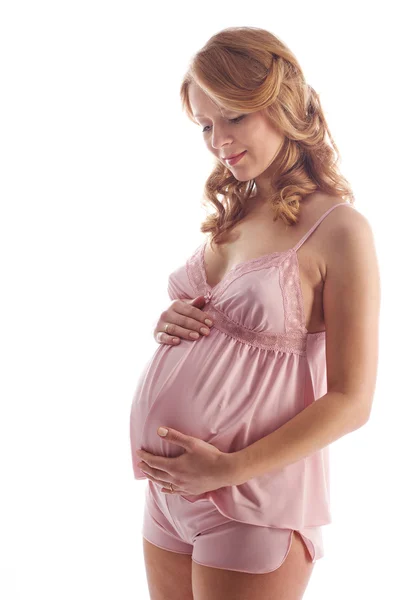妊娠中の女性は笑みを浮かべて、腹を見て — ストック写真
