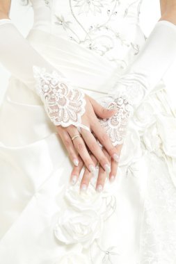 Bride's hands with manicure in white lace gloves clipart
