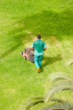 Man mowing grass clipart