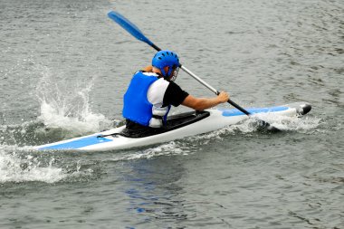 Man racing in kayak clipart