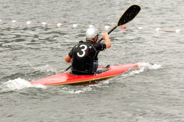 Man paddling in his kayak clipart