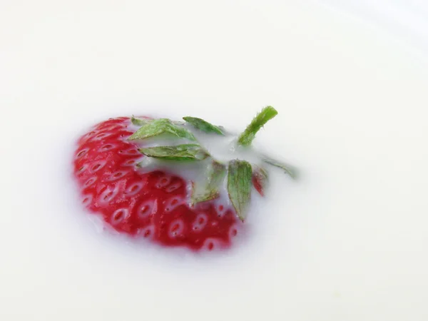 Strawberry in a milk — Stock Photo, Image