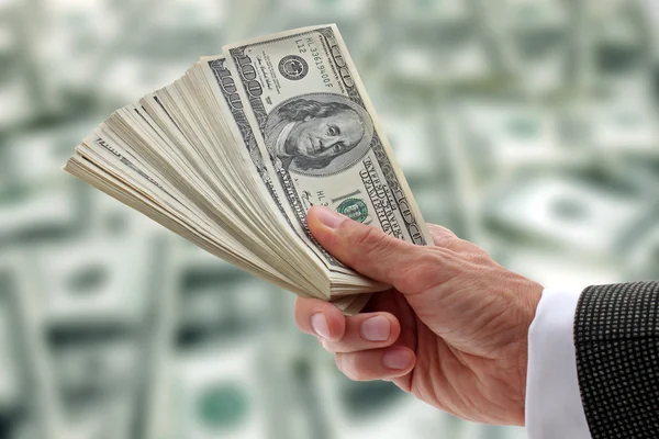 Businessman holding dollars — Stock Photo, Image