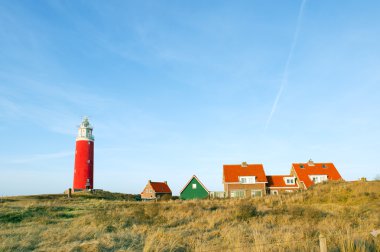 Red lighthouse in the dunes clipart