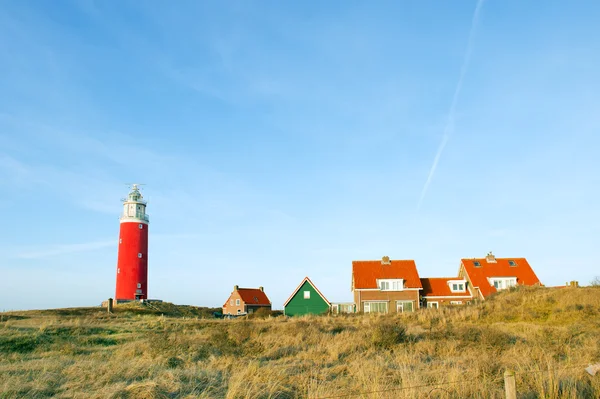 Red lighthouse in the dunes — Stock Photo, Image