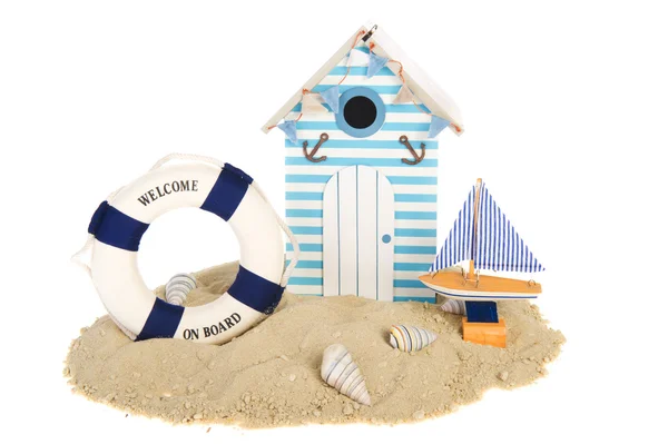 Beach hut with sailing boat and life buoy — Stock Photo, Image