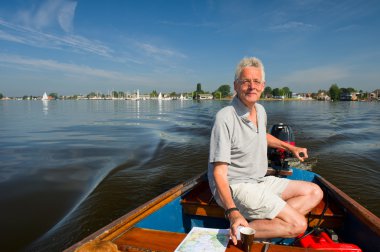 Elderly man in boat clipart